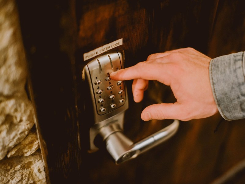 a hand holding a remote control