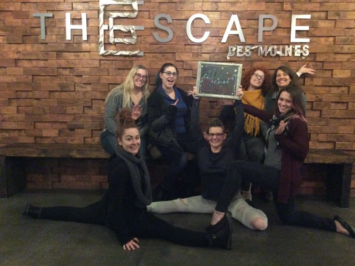 a group of people sitting in front of a brick wall