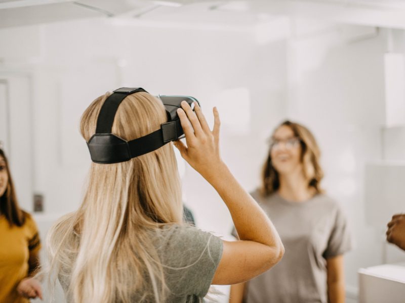 a woman standing in front of a mirror posing for the camera