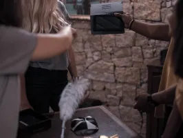 a person standing in front of a brick wall