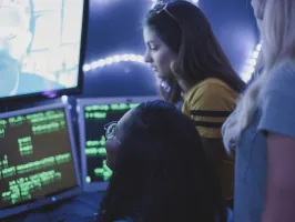 a person standing in front of a computer screen