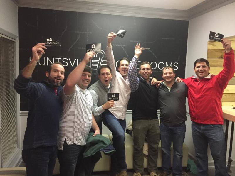 a group of people standing in front of a crowd posing for the camera